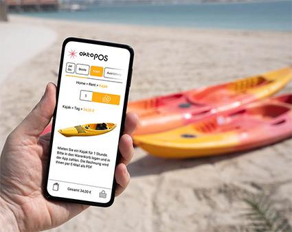 Smartphone als virtuelle Kasse mit Kanu am Strand im Hintergrund